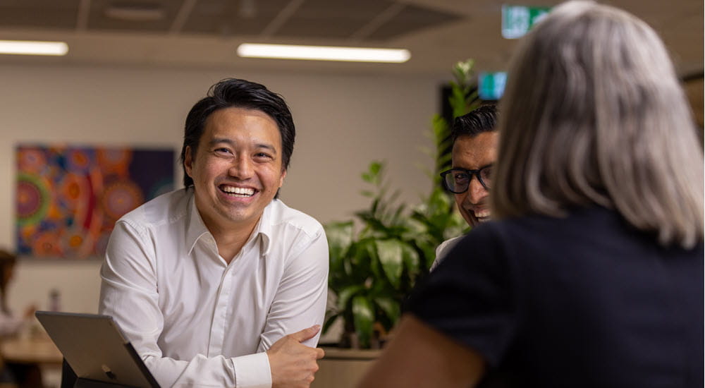 Smiling business man working with colleagues